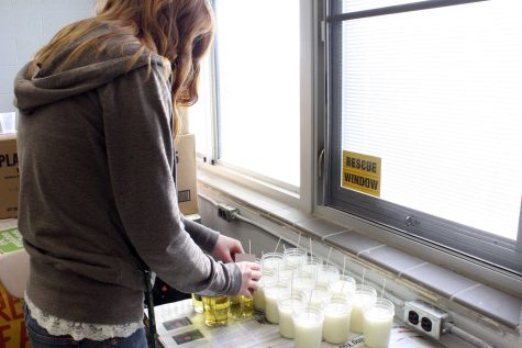 Senior Ally Glosch prepares candles to sell in the corporate services class. The group is planning a breakfast to celebrate their work.