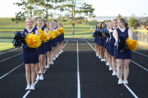 The cheerleaders dance to the Marauder fight song after the football team scores a touchdown. They won against Chesaning with a score of 23-8. | Photo by Linn Benham.