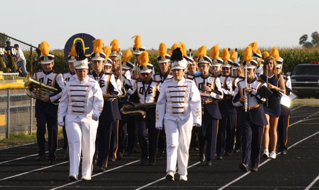 The+senior+drum+majors%2C+Jakie+Wood+and+Madrid+Nihart%2C+lead+the+marching+band+onto+the+football+field+before+the+first+home+varsity+football+game+last+Friday+night.+%7C+Photo+by+Michaela+Post