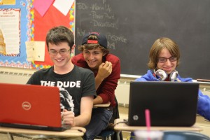 Looking at computers seniors Dalton Butts, Hunter Charvat, and junior  Dylan Kernohan wait for the Student Council meeting to start. | Photo by Lindsay Benham