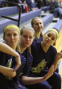 Sophomores Brittney Moore, Cheyanne Munson, Morgan and Danielle Martin sit and support their Varsity teams. | Photo by Jessi Witt