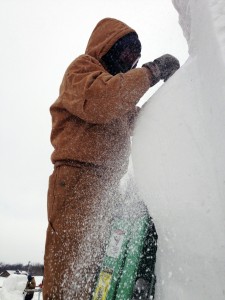 Snow sculpter sculpts away at the seahorse that got them second place. | Photo by Laura Weber