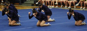 The Varsity Competitive Cheer team pounds the floor as they demand the win at their district competition held on February 15, 2014. 