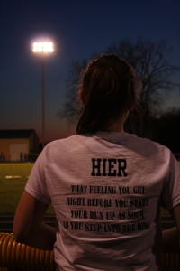 Senior Alexis Hier watches and supports her team mates at the first home TVC of the 2014 track season. | Photo by Maddie Putnam