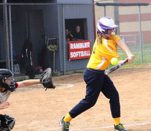 Sophomore Kari Fogarty hit the ball gaining a run for the JV girls against Perry. |Photo by Michaela Post