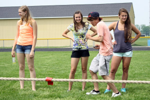 Juniors Megan Black, Logan Trefil, Dylan Kernohan, and Lacey Micka help out at field day for the elementary students. | Photo by Linn  Benham 