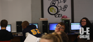 Junior Kyle Wendling pokes his head out as he works in computer lab. |Photo by: Jeanelle Courtnay