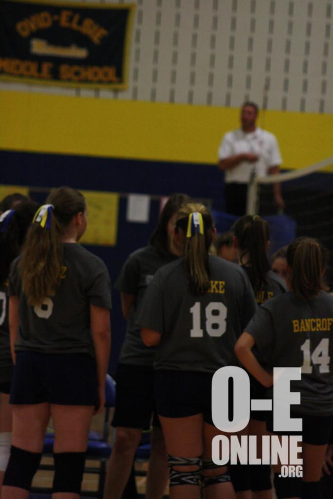 The 8th grade girls circling around their coach discussing what their next move is. |Photo by Mikyala Baese