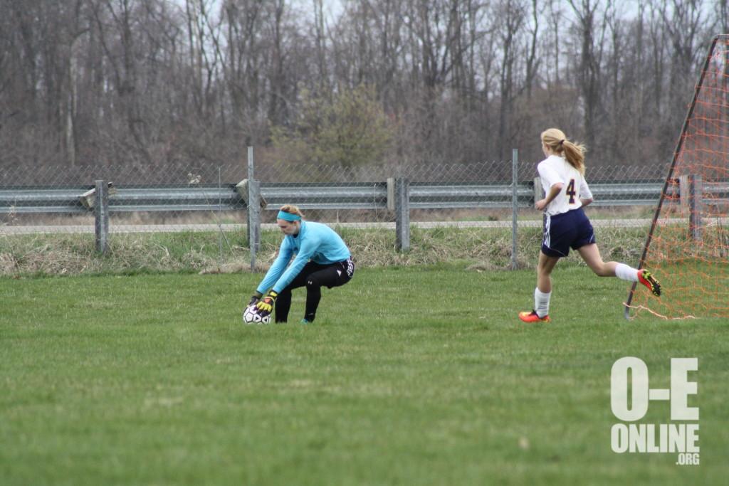 Striker Katie Davis crashes the net during her J.V. game. |Photo by AJ Larsen