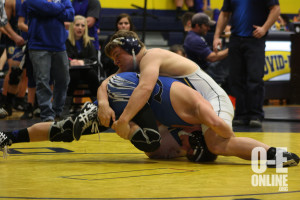 Freshman Zach Morris works to pin his opponent. | Photo by Molly Maynard